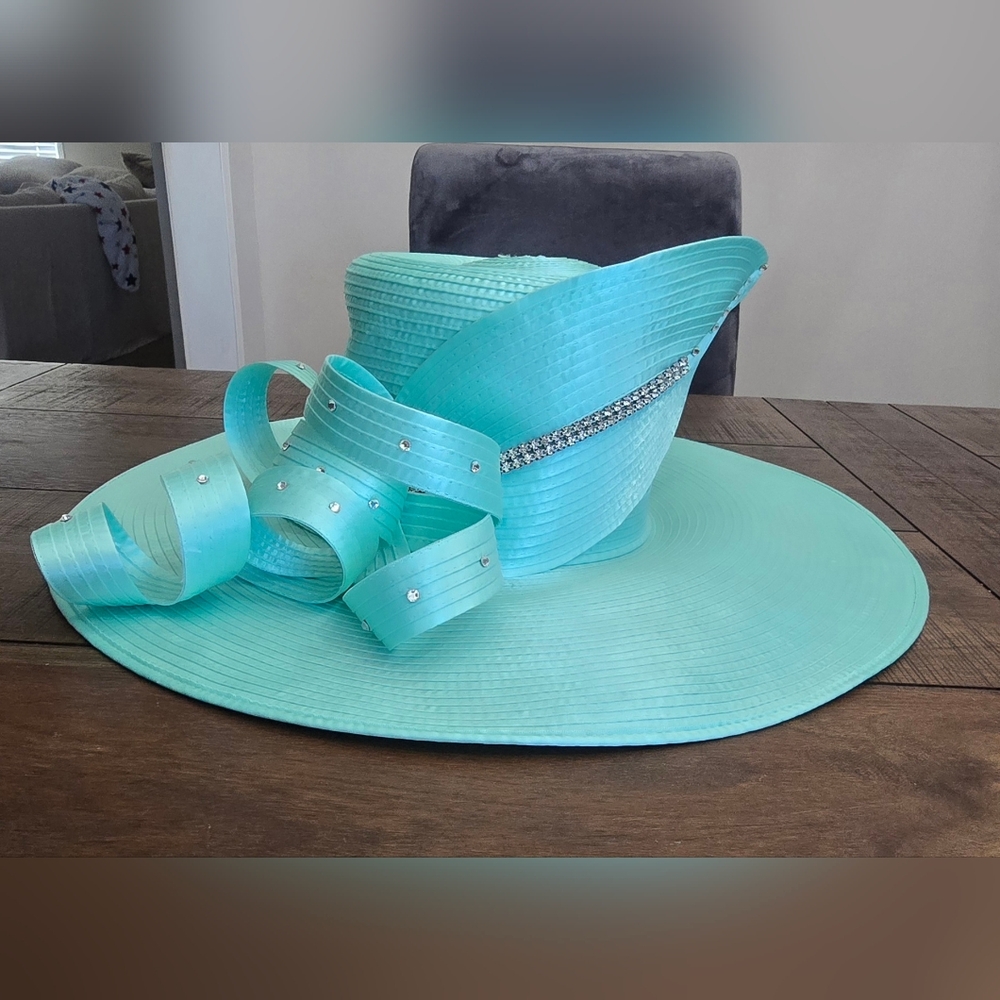 Lily & Taylor Couture. Teal hat with rhinestones accents.